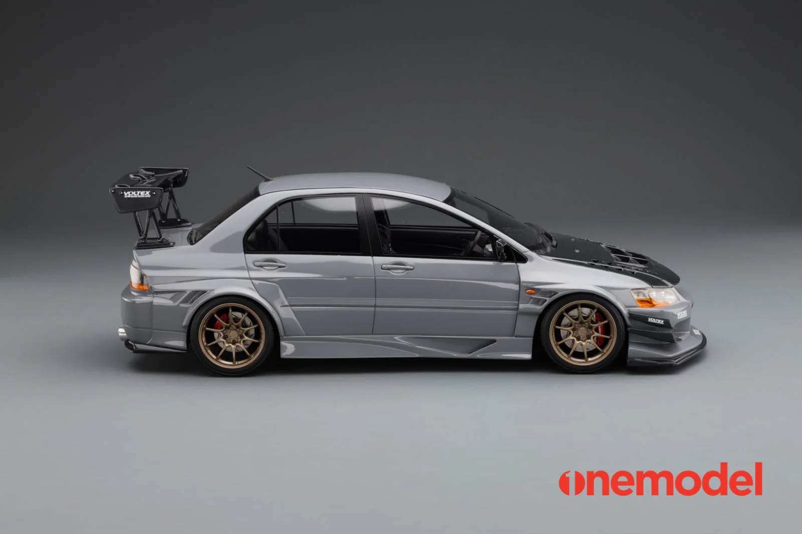 One Model 1:18 Mitsubishi Lancer Evolution IX Voltex with Carbon Bonnet in Cement Gray - Image 2